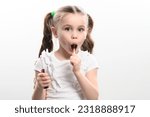 Little girl licks lollipop and...