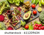 Healthy vegan food. Fresh vegetables on wooden background. Detox diet. Different colorful fresh juices.