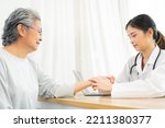 Small photo of Female doctor using hand to checking the pulse. Doctor checking patient's pulse. medical check up.