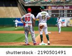 Small photo of Oakland, California - August 10, 2022: Los Angeles Angels first base coach Damon Mashore and Oakland Athletics first baseman Seth Brown talk in between innings at the Oakland Coliseum.