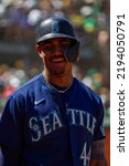 Small photo of Oakland, California - August 21, 2022: Seattle Mariners outfield Julio Rodriguez smiles in the on deck circle during a game against the Oakland Athletics at the Oakland Coliseum.