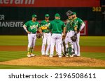 Small photo of Oakland, California - July 23, 2022: Oakland Athletics manager Mark Kotsay on the mound with the infield after making a pitching change in a game against the Texas Rangers at the Oakland Coliseum.