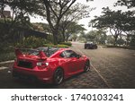 Small photo of Tangerang, Indonesia - August 4, 2018: Red Toyota FT86 is chasing the Mitsubishi EVO X