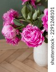 Small photo of Peonies in a white vase. Peony Bud. macro flower bud. delicate pink flower petals. The buds of peonies are a symbol of the rebirth of nature; arrival of spring. A fresh bud of peonies