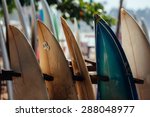 Small photo of Set of different color surf boards in a stack by ocean.WELIGAMA, SRI LANKA. Surf boards on sandy Weligama beach. On Weligama beach surf is available all year around for beginner and advanced.