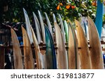 Small photo of Set of different color surf boards in a stack by ocean. WELIGAMA. Surf boards on sandy Weligama beach in Sri Lanka. On Weligama beach surf is available all year around for beginner and advanced.