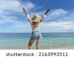 a woman is resting on the beach.... | Shutterstock . vector #2163993511