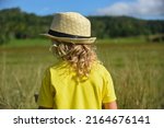 a little curly haired boy walks ... | Shutterstock . vector #2164676141