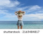 a woman is resting on the beach.... | Shutterstock . vector #2165484817