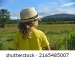 a little curly haired boy walks ... | Shutterstock . vector #2165485007