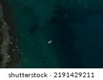Small photo of Aerial top nature view drone above yacht ship turquoise Adriatic sea in Albania. panoramic view marine. summer wallpaper. dark calm water rock bottom. mountain coast seaside. texture pattern mockup