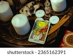 Small photo of Tel-aviv, Israel, 22 of September, 2023: The tarot cards with candles and magic objects. Halloween concept, ritual or spell with occult and esoteric symbols, divination rite. Love magic