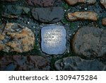 Small photo of Basel, Switzerland - February 24, 2007: a piece of metal engraved in the pavement in the style of a stumbling stone with the writing "here the love between Gabriele and Harald began to blossom (date)"