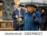 Small photo of Hamburg, Germany - March 31, 2023: close up portrait of Queen Consort Camilla during the wreath-laying ceremony at St. Nicolai memorial under an umbrella with white rose in hand
