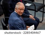 Small photo of Berlin, Germany - March 30, 2023_ close up portrait of King Charles III. - he sits on a chair in the German parliament "Deutscher Bundestag" and turns his head back and looks mischievously
