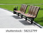 Wooden benches against the background of green grass