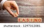Small photo of Man puts cubes with the word Leasing. A lease is a contractual arrangement calling for the lessee to pay the lessor for use of an asset. Property, buildings, vehicles are common assets that are leased