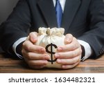 Small photo of Businessman hugs US dollar money bags. Bank deposit. Budget management, tax collection. Trade, economics. Granting financing business project or education. Provision financial loan credit. Corruption