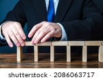 Small photo of A man building a bridge of domino blocks. Strategy planning business expansion. Development and progression. Leadership. Create, design, expand a company. A stable foundation movement towards the goal