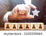 Small photo of A businessman is holding a star over the team. Awarding. High appreciation and reward for work. Optimal team size, efficiency and productivity. Recruiting the best job applicants.