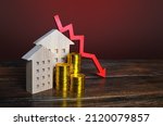 Red down arrow and houses. Falling real estate market. Low housing prices. Reduced mortgage rates. Crisis. Maintenance cost. recession. Housing bubbles burst. Bankrupt and foreclose. Affordable home
