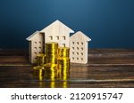 Small photo of Residential buildings and coins stacks. Municipal budgeting. Tax collection, investments in city development. Profitability of rental business. Valuation of real estate. Property taxes. Content cost.