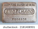 Small photo of Edwardsville, IL-5 24 2016: Ten-troy ounce bar of .999 plus silver on blue background.