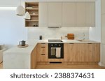 Small photo of Japandi style modern kitchen interior design with decorations in beige and nut colours with led light illumination