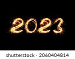 New Year 2023 light. Sparklers draw figures 2023. Bengal lights and letter