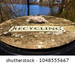 The lid or top of an old rustic antique wooden barrel used for recycle collection on the grounds at Yates Mill County Park in Raleigh North Carolina, Triangle area, Wake County.