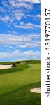 Small photo of Golf course green with beautiful cloudy sky