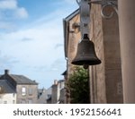 Small photo of Port-en-Bessin-Huppain, France, March 2021. Old ringtone, bell before entering the house, photo close up