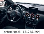 Modern and sport car interior with comfortable dark leather seats, multimedia and dashboard