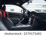 Modern supercar interior with leather panel, sport seats, multimedia and digital dashboard