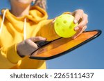 Pickleball paddle and yellow...