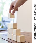 Small photo of Arrange the wooden blocks into steps, higher the marketing strategy the more effort is required, Ladder of success, Driving business at the peak concept.