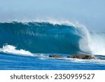 A wave breaks down a sandy point in rural Mozambique.