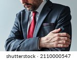 Small photo of Arms gripping, restrained insecure businessman waiting for bad news, crossed arms posture body language, selective focus