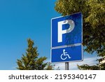 Reserved parking space sign, handicapped person with disability in wheelchair pictogram, selective focus