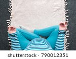 Small photo of Overhead view of pregnant woman practicing yoga exercise at home. Pregnancy yoga and indoors fitness concept. Ungraded low contrast footage with natural window light.