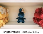Small photo of Schiphol, Netherlands - October 7, 2019: A single blue Miffy in the middle of other coloured stuffed toys.