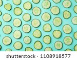 Flat lay composition with slices of cucumber on color background