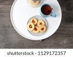 Traditional Christmas Linzer cookies with sweet jam on table, top view