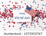 Flat lay composition with greeting card, USA flag and confetti on white background. Happy Independence Day