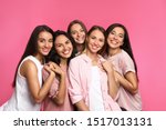 Happy women on pink background. ...