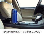 Blue thermos in holder inside of car