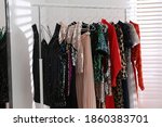 Different stylish women's clothes on rack indoors