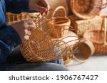 Woman Weaving Wicker Basket...