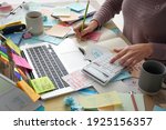 Small photo of Overwhelmed woman working at messy office desk, closeup