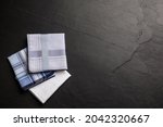 Different handkerchiefs folded on black table, flat lay. Space for text